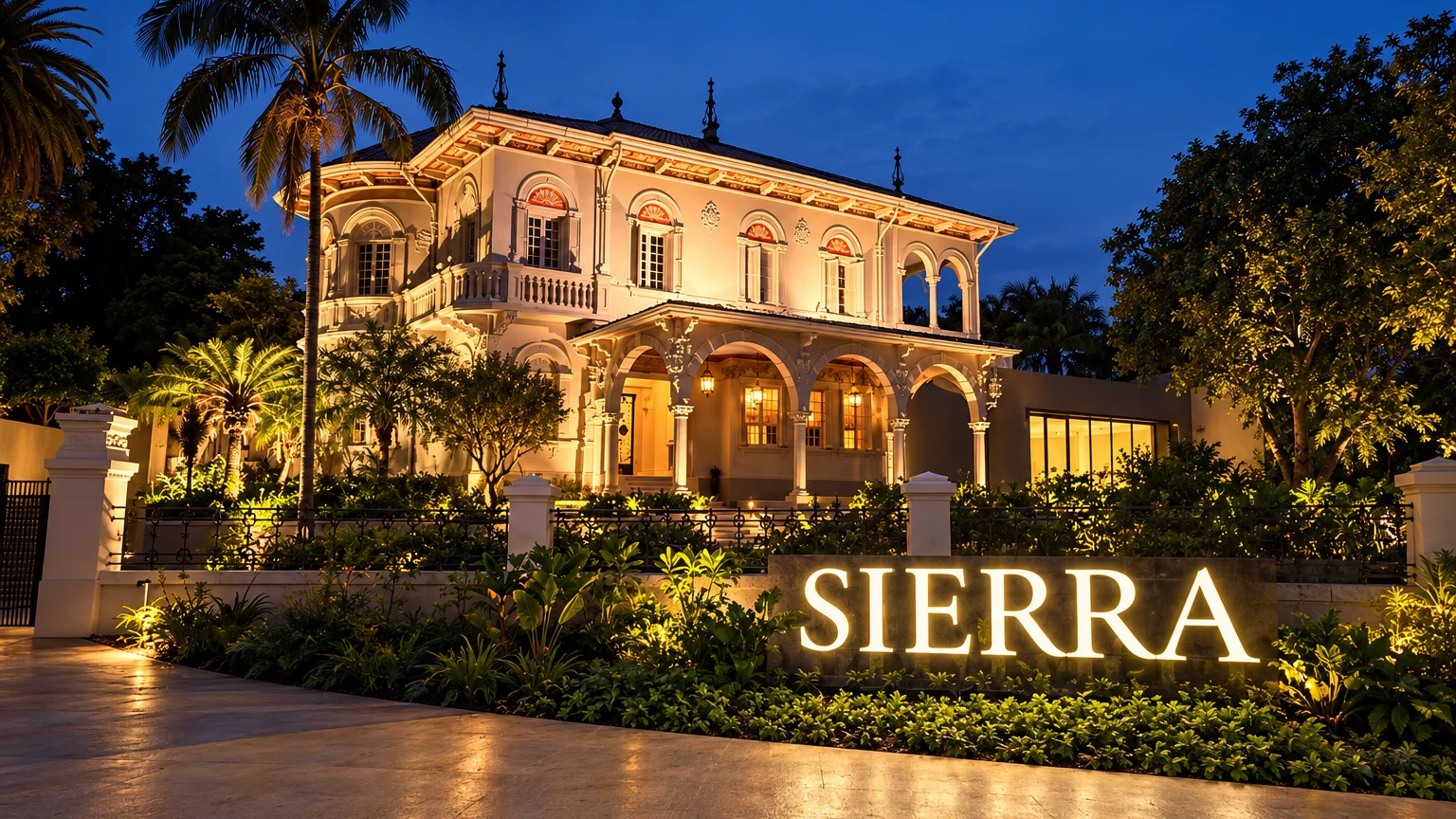 Fachada iluminada da Sierra Flagship em São Paulo à noite, casarão com jardim e letreiro SIERRA em primeiro plano.